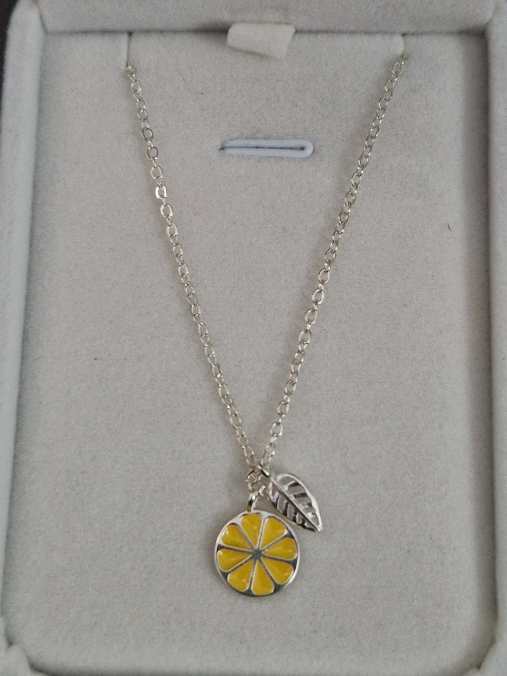 A Beautiful Slice of Lemon with leaf. Hallmarked Silver Necklace. 18 inches.
