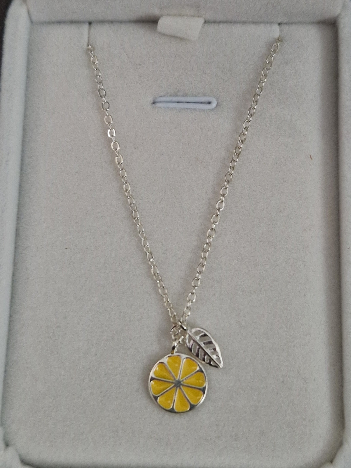 A Beautiful Slice of Lemon with leaf. Hallmarked Silver Necklace. 18 inches.